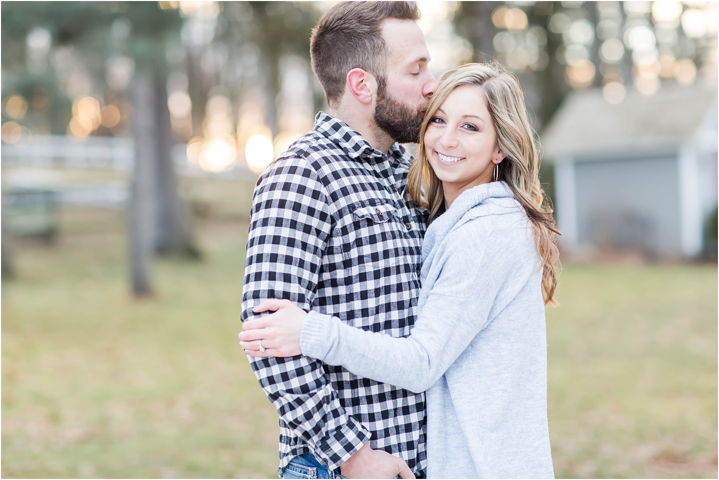 winter engagement photos, groom kissing bride on the temple