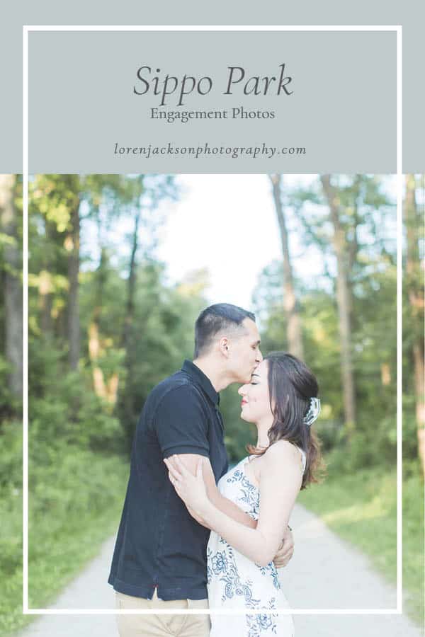 Groom kissing bride's forehead at Sippo Lake Park for engagement photos photographed by akron wedding photographer