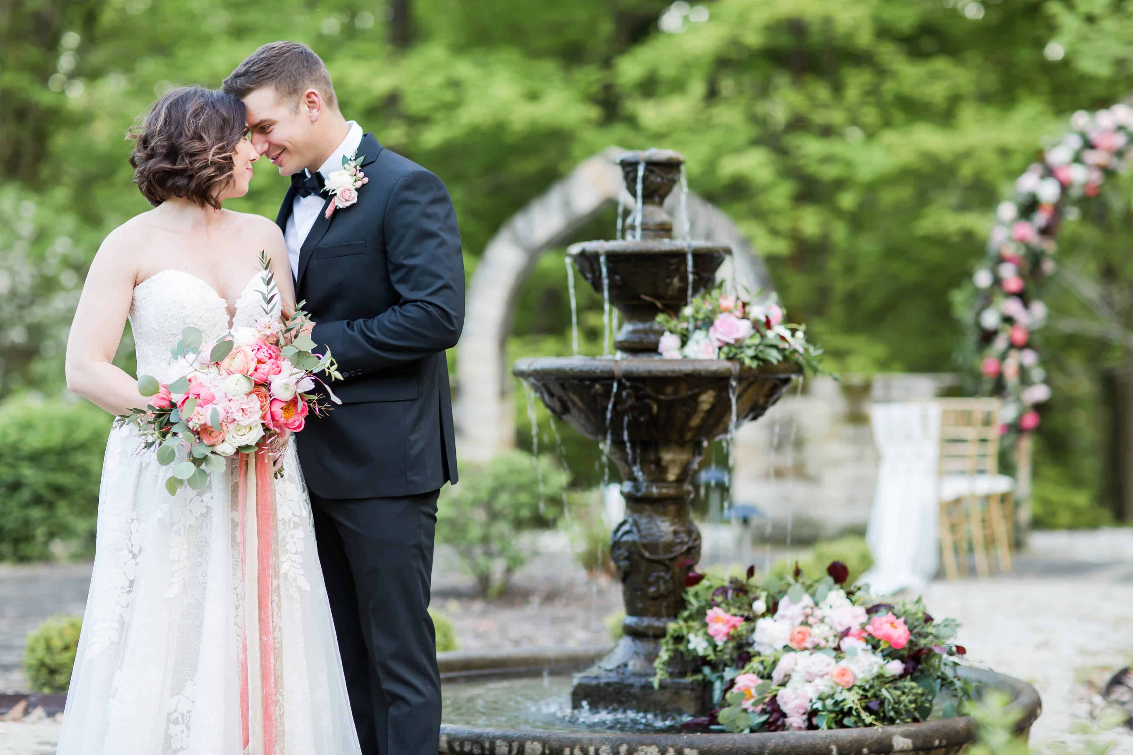 bride and groom looking at each other during coral and peach styled shoot at purcell mansion photographed by akron ohio wedding photographer