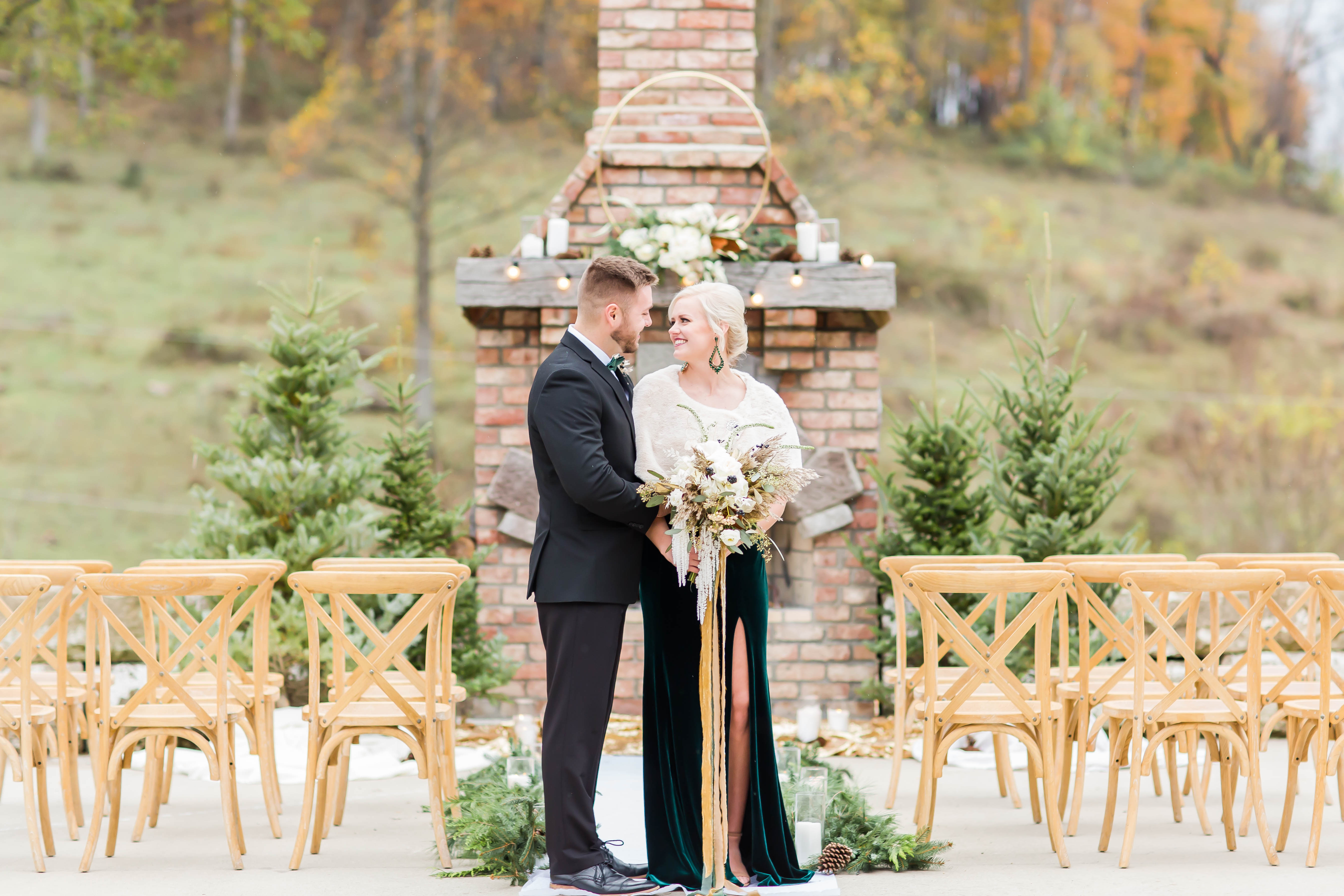 Bride and groom standing by fire place at Rivercrest Farm in Dover ohio photographed by akron ohio wedding photographer loren jackson photography