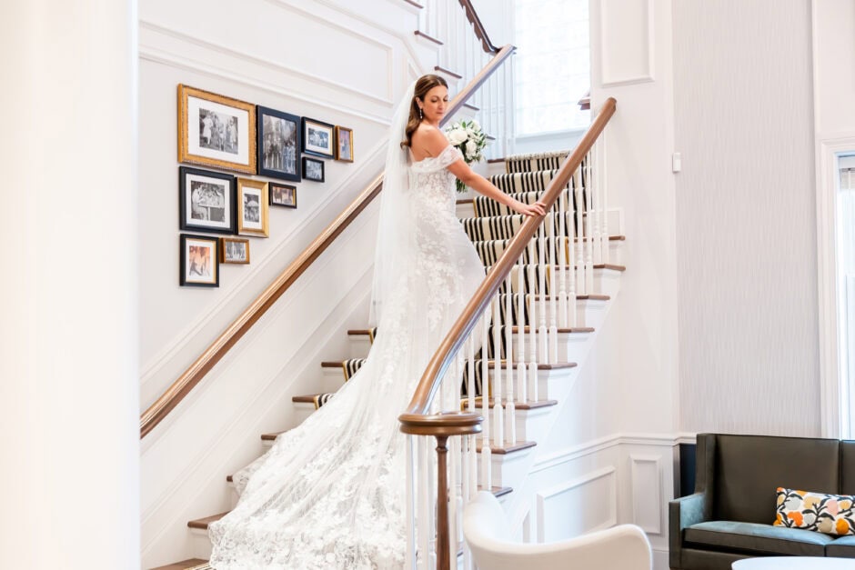 Bride descending a grand staircase in a lace wedding gown at The Blaire Center, photographed by Loren Jackson Photography for brides visiting Cleveland Ohio bridal shops.