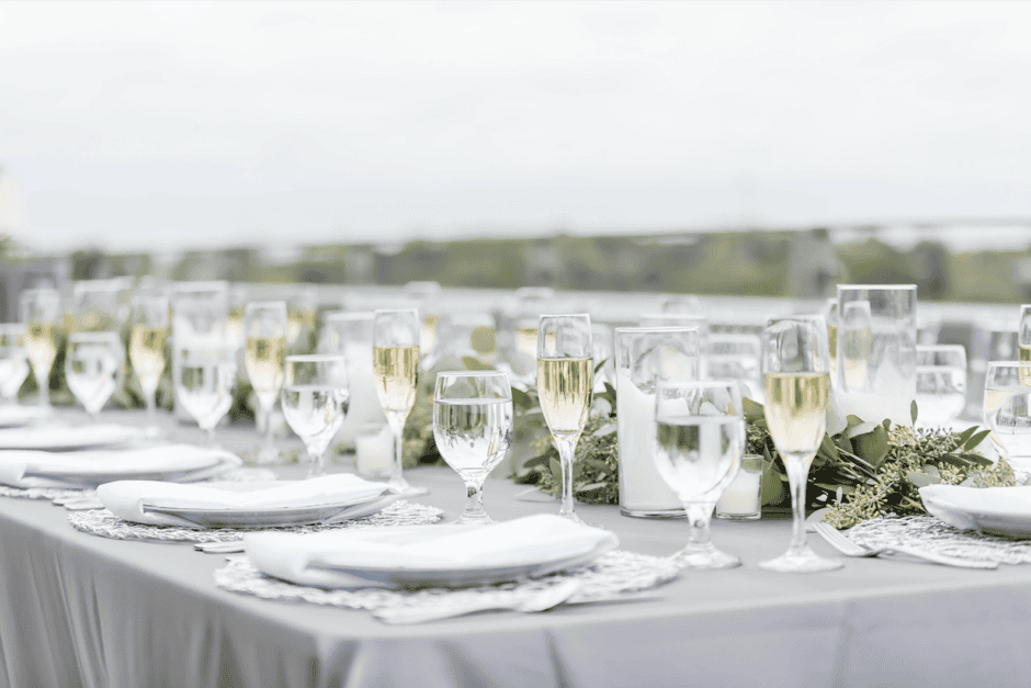 Elegant wedding reception table with champagne and greenery at Pro Football Hall of Fame, photographed by wedding photographer Cleveland OH with Sirpilla Soirée